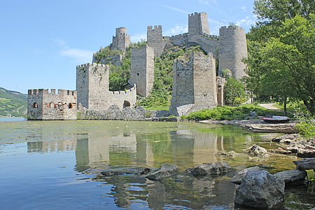 castle beside body of water during daytime thumbnail