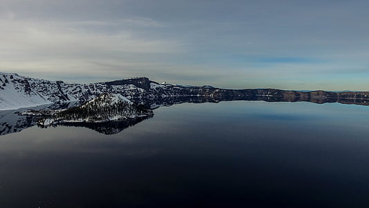 snow covered mountain beside lake thumbnail