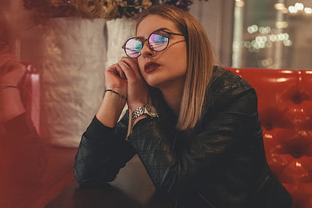 woman sitting on red leather sofa thumbnail