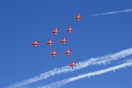 nine red jet planes doing with jet streams during daytime thumbnail