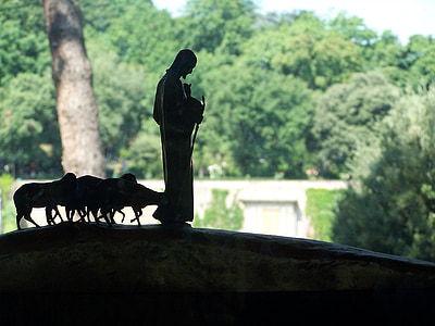silhouette photography of man leading the sheep figurine thumbnail