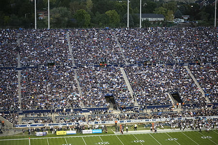 people watching football game during daytime thumbnail