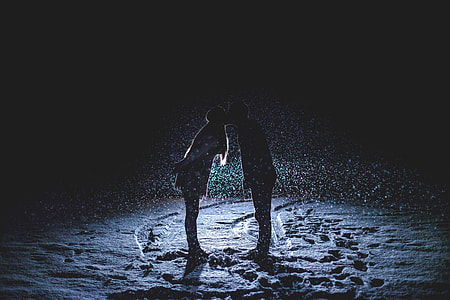 silhouette of coupe kissing in front of a car thumbnail