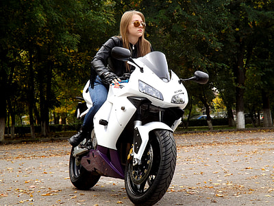 woman sitting on white motorcycle thumbnail