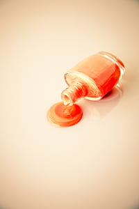 spilled bottle of nail enamel on white surface thumbnail