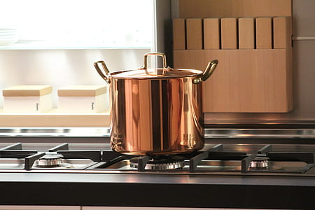 gold-colored stock pot on grey gas stove thumbnail