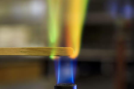 Copper solution burning on a wooden splint in a bunsen burner flame. thumbnail