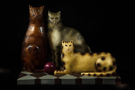 three brown, yellow, and gray cat figurines thumbnail
