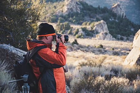 Photograph of a Man Taking Pictures Outdoors thumbnail