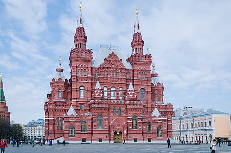 red castle surrounded by buildings thumbnail
