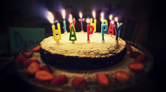 cake with strawberry and lighted candles thumbnail