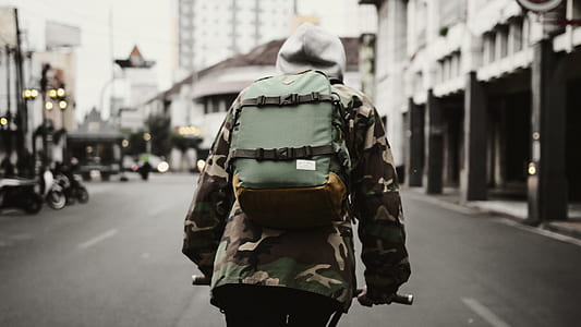 selective focus photography of person riding bike thumbnail