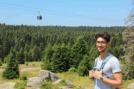 smiling man with blue backpack thumbnail