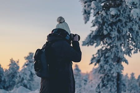 person taking photo using DSLR camera thumbnail