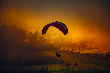 person riding parachute during daytime thumbnail