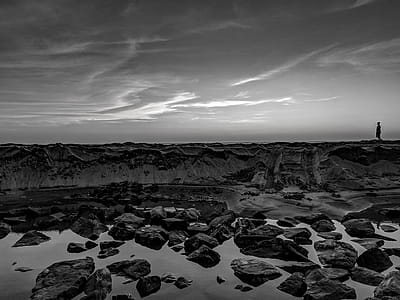 Grayscale Photo Of Person Walking On Rocks thumbnail