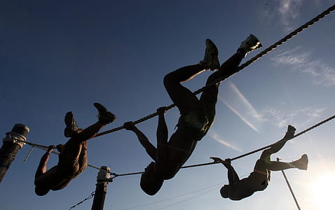 Three Man Climbing on Rope Under the Sunset thumbnail