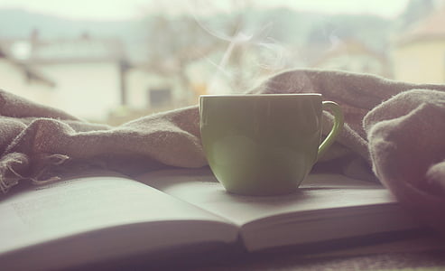 green ceramic cup on book thumbnail