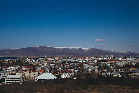 aerial photography of village and mountain view under blue sky at daytime thumbnail