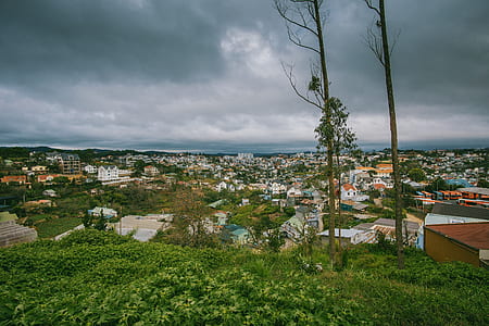 Scenic View of City Under Cloudy Sky thumbnail