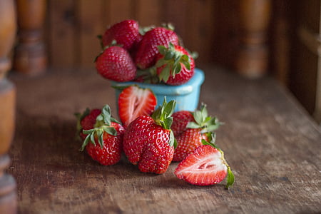 red strawberries on brown wooden surface thumbnail