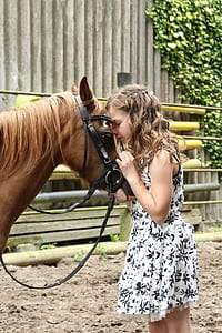 girls wearing floral dress beside the horse thumbnail