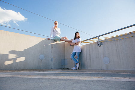 two women wearing white shirts thumbnail