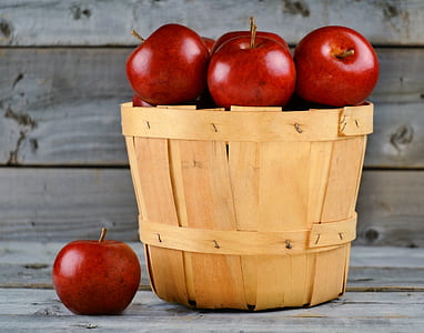 bunch of red apples in brown wooden bucket thumbnail