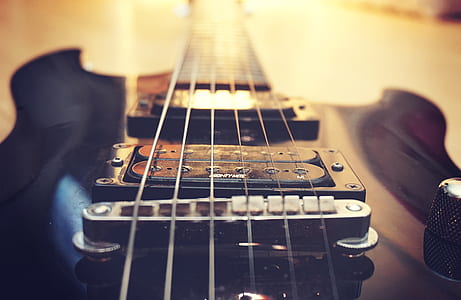 selective focus photography of black electric guitar thumbnail
