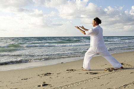 Man dressed in White Practicing Tai-Chi on the Beach thumbnail