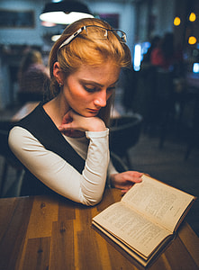 woman reading book on table thumbnail