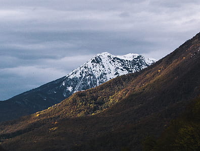 white and black glacier mountain under cloudy sky thumbnail