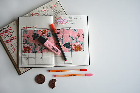 flat-lay photography of weekly planner with pen and highlights on top thumbnail