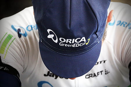 person wearing blue cap and white top thumbnail
