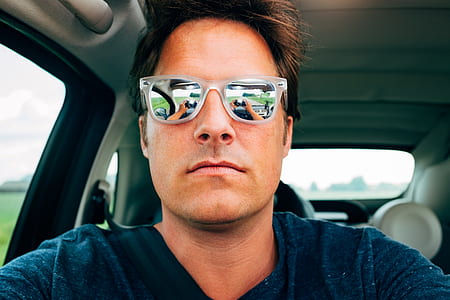 man inside car wearing sunglasses thumbnail