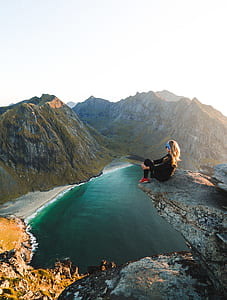 woman sitting beside cliff thumbnail