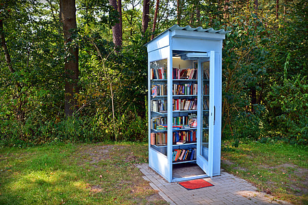 white wooden shelf filled with books on outdoors thumbnail