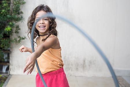 girl playing hoola hoop at daytime thumbnail