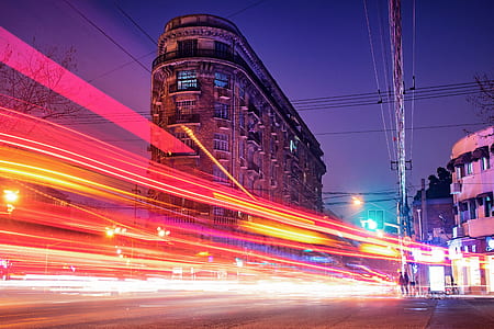 timelapse photography of road lights near buildings thumbnail