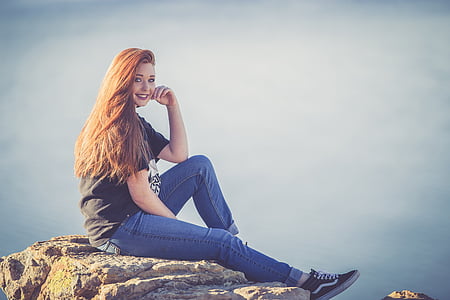 woman sitting on rock on mountain top thumbnail
