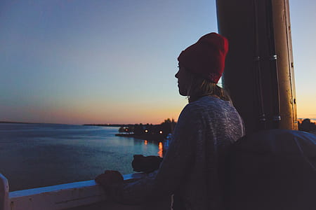 woman looking at body of water during nighttime thumbnail
