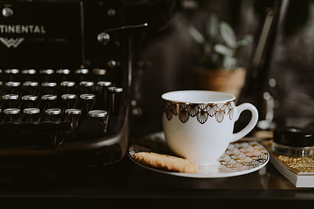 Coffee in a decorative cup with a golden ornament thumbnail