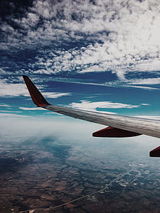 selective focus photography of white airliner wing thumbnail
