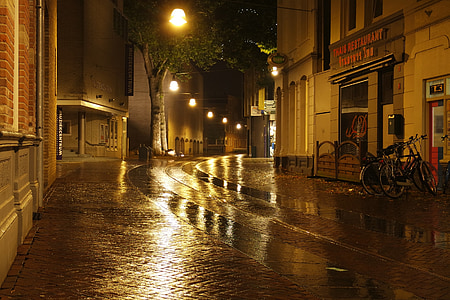 wet road and concrete buildings thumbnail