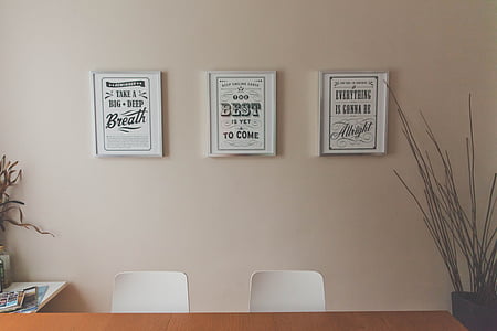 closeup photo of three decors on beige wall thumbnail