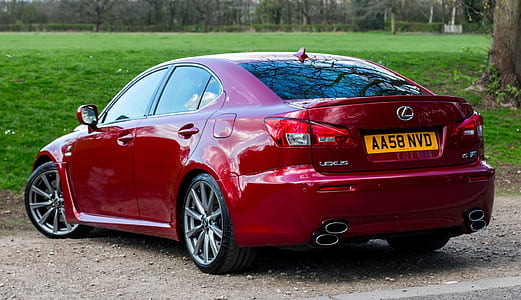 red Lexus sedan parked near grass field thumbnail