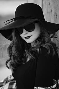 grayscale photo of woman wearing black sunhat thumbnail