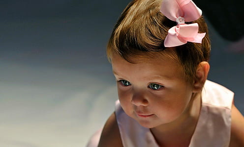 toddler girl wearing white sleeveless top with pink bow thumbnail