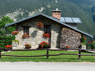 gray stone house with mountain range view thumbnail