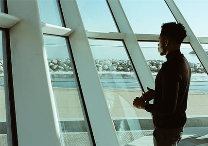 man standing in front of glass building thumbnail